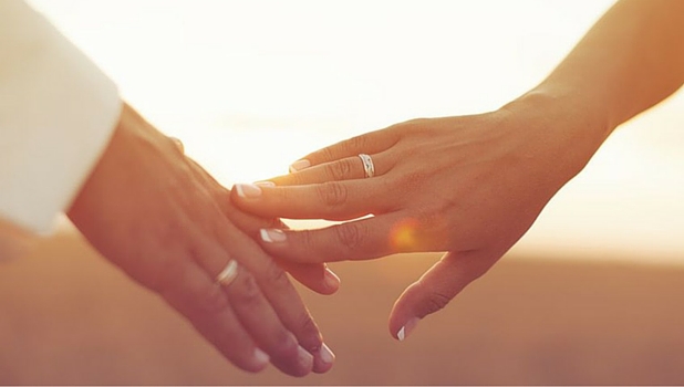 Married couple holding hands