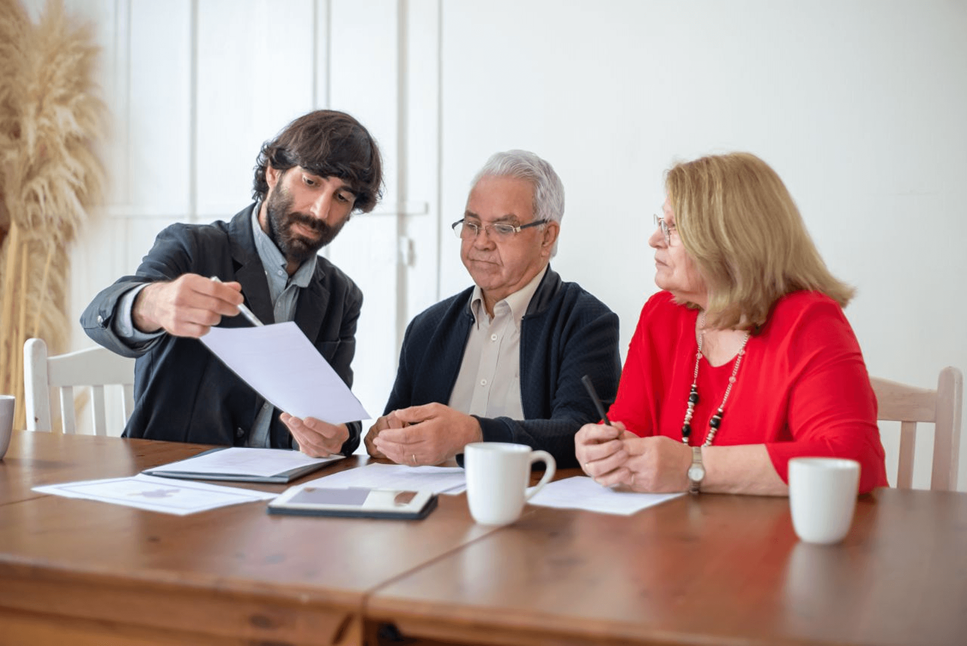 Adviser going through documents with an older couple at a table