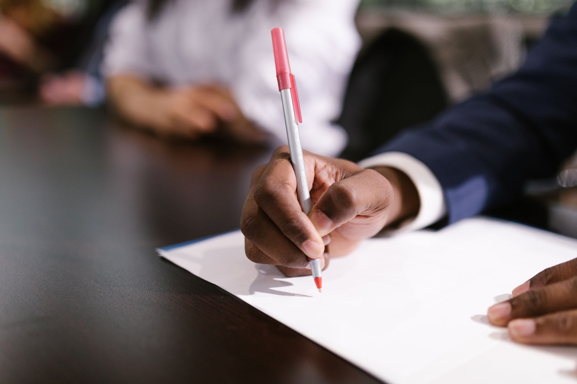 Taking notes during a formal workplace meeting